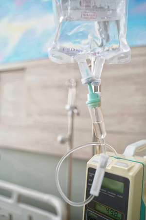 The fluid intravenous drip saline dropping for the admit patient in the room at hospital.の写真素材