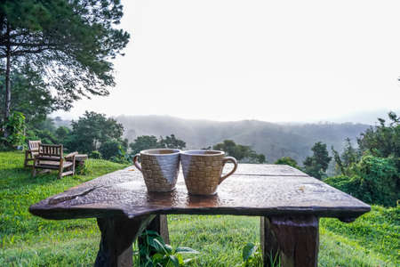 A couple coffee cup with mountain natural view in the morning time at Khao Kho, Thailand.の写真素材