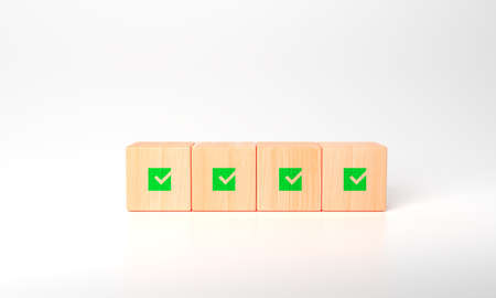 3d rendering Corporate regulatory and compliance. Quality control management, ISO certification. Product, service quality warranty. Checklist survey. wooden cube with check mark green icon.の写真素材
