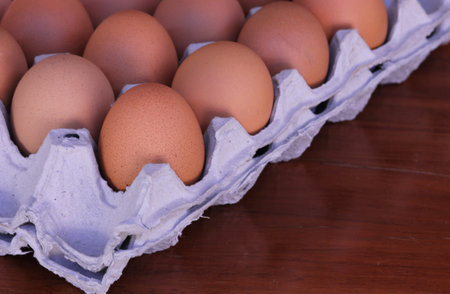 Brown Eggs in Carton on wood