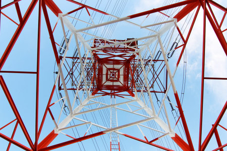 Steel electricity pylon on bright blue sky