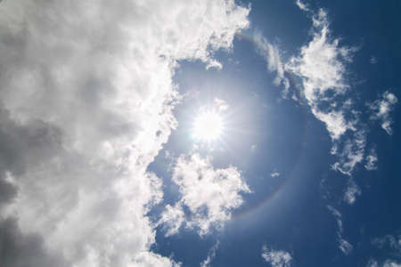 Circular Rainbow Around Sun with cloudsの写真素材