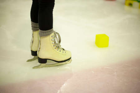 Figure skating on ice rink, closeup of legs and skatesの写真素材