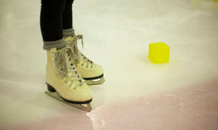 Little girl learns to skate. Children's skates. A child training on ice. The concept of children's figure skating. Children's sports. Winter sportの写真素材