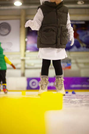 Little girl learns to skate. Children's skates. A child training on ice. The concept of children's figure skating. Children's sports. Winter sportの写真素材