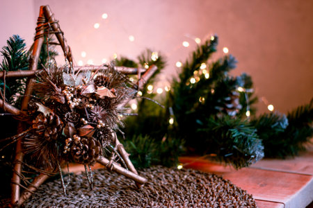 christmas decorations star with fir branches and defocus lights. Selective focus