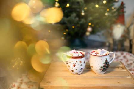 Christmas card with a Christmas tree, gnomes, beautiful mugs with marshmallows. Christmas Concertの写真素材