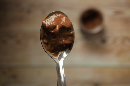 Chocolate yogurt in a spoon, close-up
