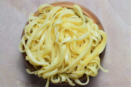 Pasta of noodles in wooden bowl