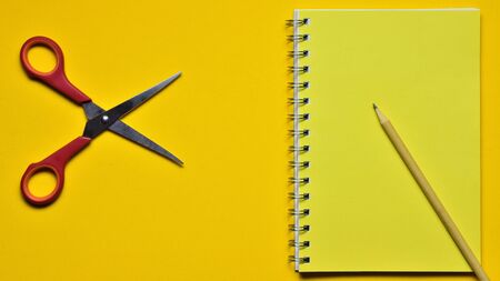 Yellow background with school accessoriesの写真素材