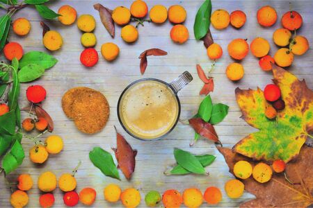Cafe con leche, with cookies and decorated with strawberry trees and forest leavesの写真素材