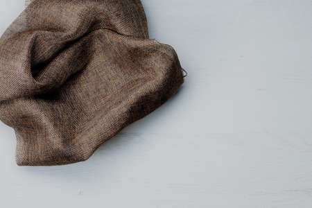 Brown fabric on wooden board, space for textの写真素材