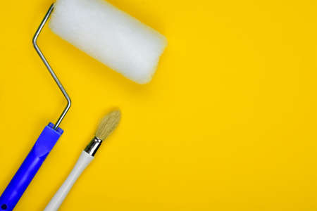 Painting utensils on yellow background, space for textの写真素材