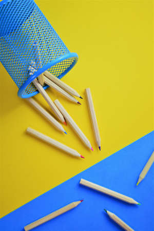 Fallen colored pencils on bicolor backgroundの写真素材