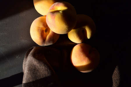 Peaches, rustic atmosphere, natural light from the window, space for textの写真素材