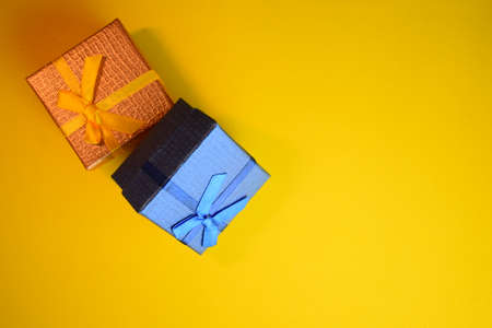 Small gift boxes on yellow backgroundの写真素材