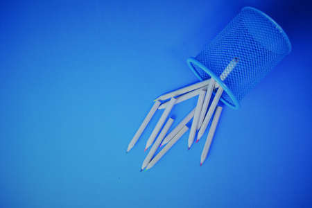 Fallen colored pencils on blue backgroundの写真素材