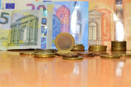 Background euro coins and bills of different amounts