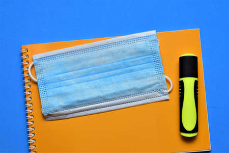 Surgical mask, virus prevention, school or office supplies on blue backgroundの写真素材