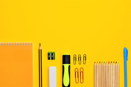 Back to school. School supplies and newspapers at school, on yellow background, space for text