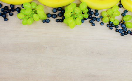 Zenith view. Variety of fruits, bananas, tropical berries and grapes full of vitamins, summer.