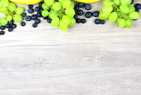 Zenith view. Variety of fruits, bananas, tropical berries and grapes full of vitamins, summer.