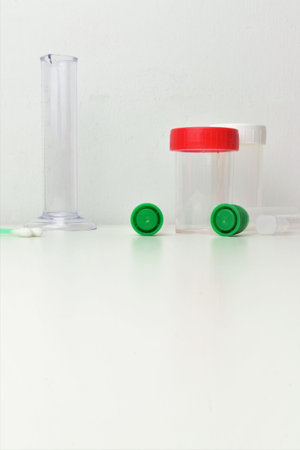 Test tubes and small laboratory containers for liquids or other tests. Space for text