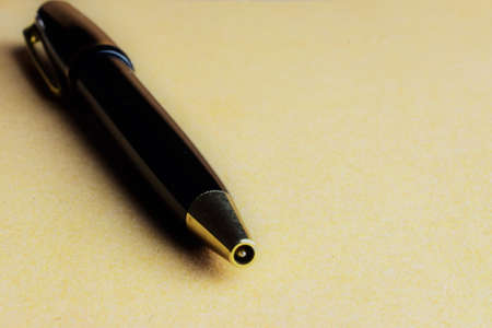 Close up, black pen with gold trimming on the notepadの写真素材
