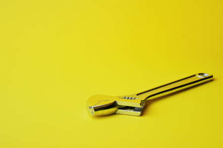 Variable wrench on yellow background, space for textの写真素材