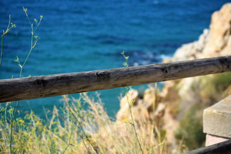 Wooden railing as security, views towards the Mediterranean Sea in the backgroundの写真素材