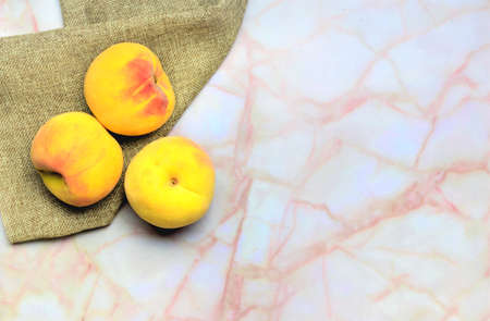 Peaches on a cloth, in the kitchen marbleの写真素材