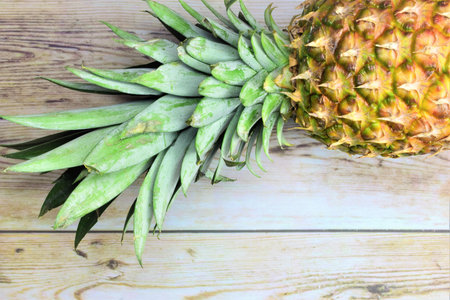 Pineapple on wooden board, refreshing tropical fruit