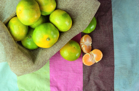 Tangerines grouped on a cloth, space for text