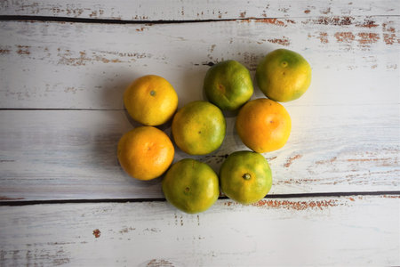Group of tangerines on white rustic boards