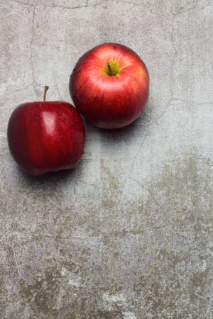 Red apple with water drops on stone background, space for text or ideaの写真素材