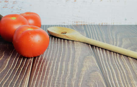 Group of tomatoes to one side, on a rustic table. Space for text or ideaの写真素材