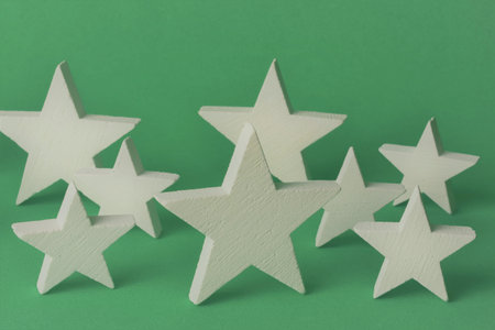 White stars on green background, representation of Christmas.