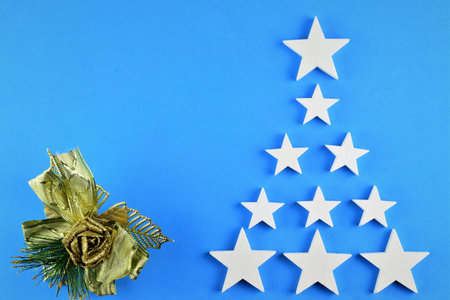Blue background with white stars and gold trim. Representation for Christmas.
