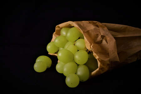 Bunch of grapes, close up. Inner kraft paper bag. Ecological. The grapes are also used to take on New Year's Eve, the well-known twelve grapes, in several Latin American countries and also in Spain.の写真素材
