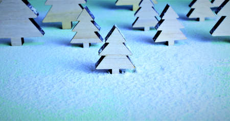 Interpreting in the shot, a macro tree in the middle of a snowy forest with more in the background, cold tones.の写真素材