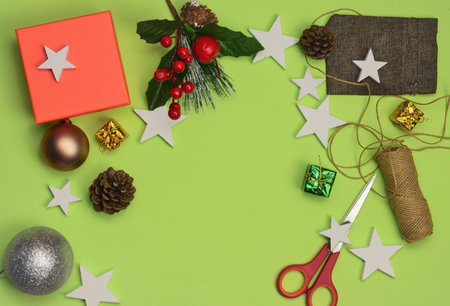 Light green background with Christmas decoration, space for text or idea. Happy Holidays.