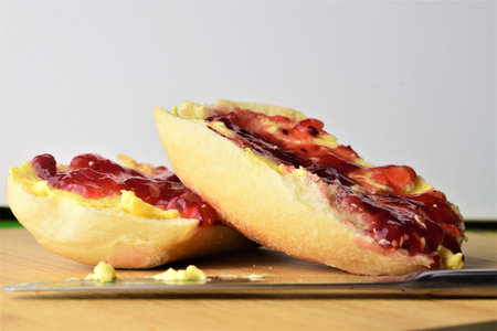 Toast with butter and berry jam on small bun