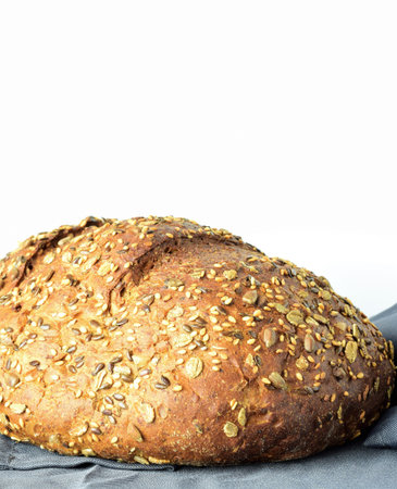 Close up. Multigrain bread on a gray cloth and white background. Copy space.