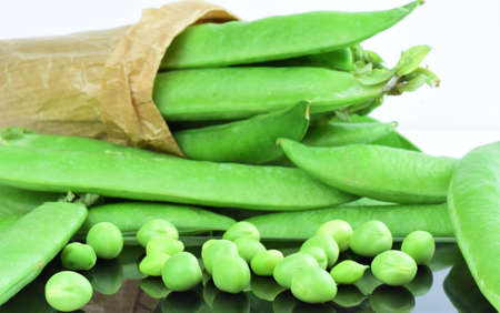 Close up, scattered peas, behind more in whole pieces, split in a kraft paper bag.の写真素材