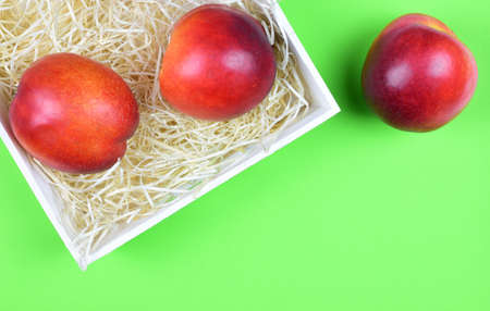 Zenith view. Group of nectarines and green background. Copy space.の写真素材