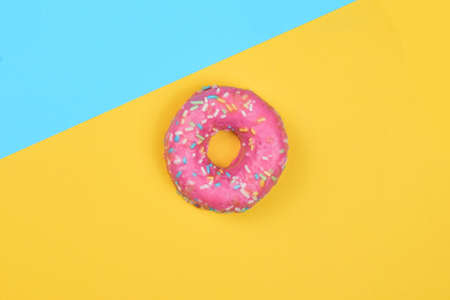 Donut with colored noodles, sweet. Two color background with overhead view.の写真素材