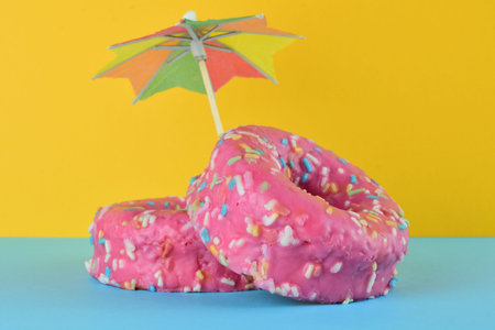 Front view. Donuts with chocolate and colored noodles. Bottom and base, two colors.