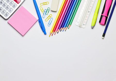 Variety of material, back to school. Copy space and light background.
