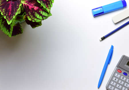 Work area, office supplies and calculator. On white background and copy space.の写真素材