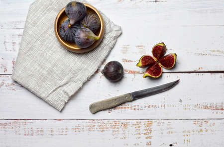 Aerial view, fruit, figs in bowl and on white wooden tables.の写真素材